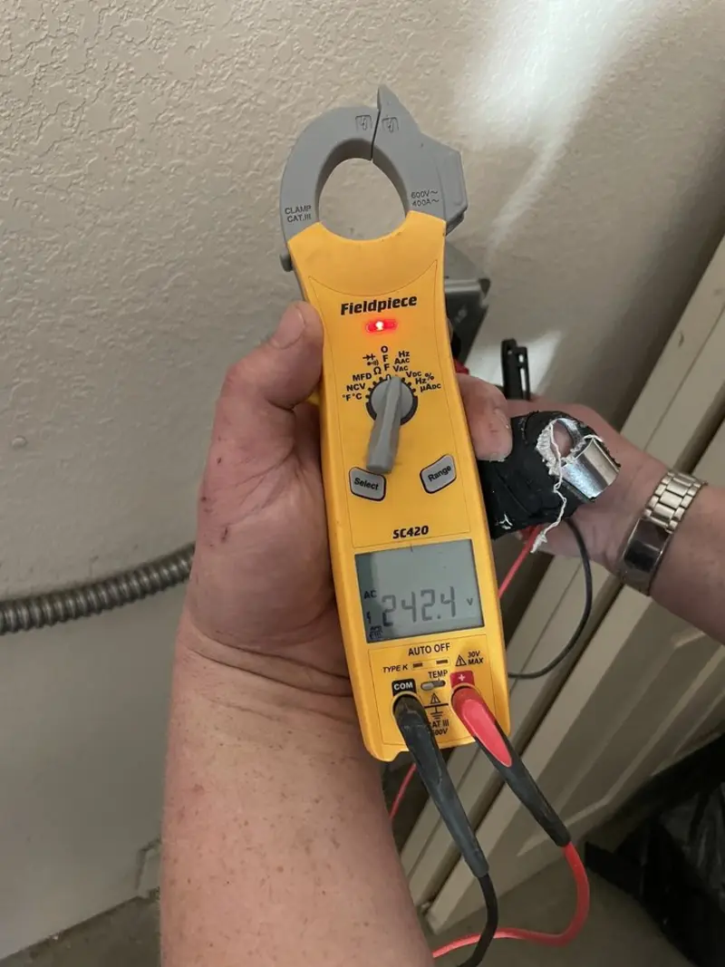 Voltage testing with clamp meter during Outlet Installation in Cedar Hills